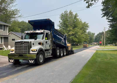 Hungerford Paving Truck on Road in front of a House